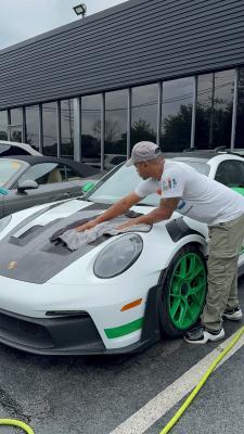 White and green sports car being polished by Mr. Tim for his mobile car wash service